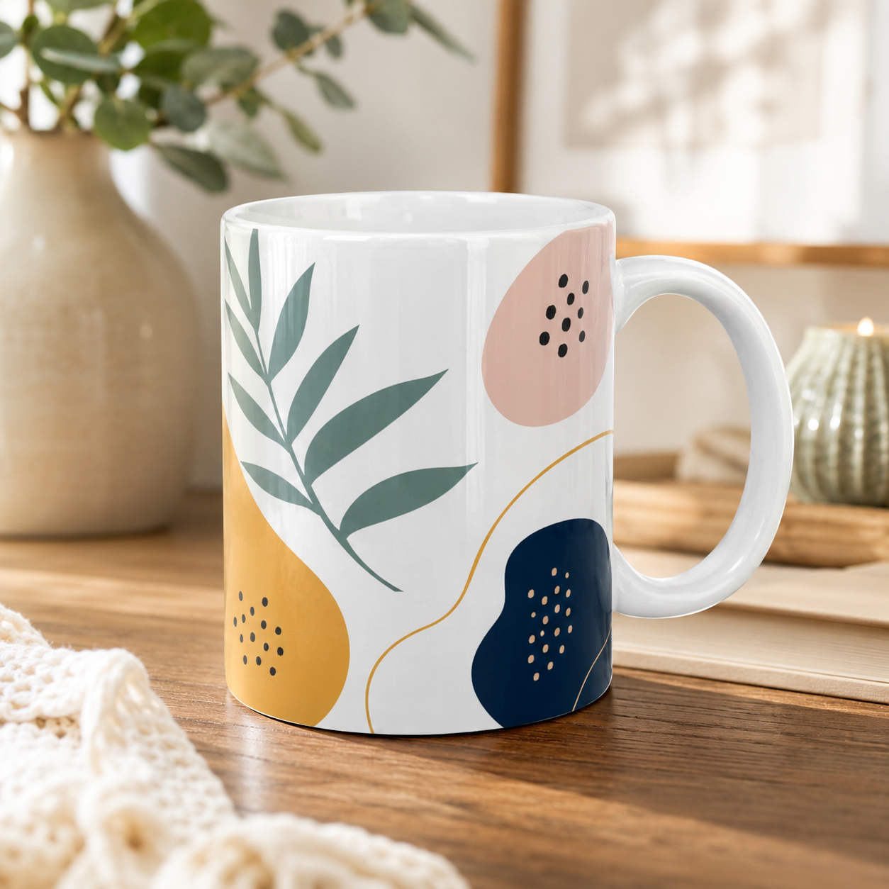 White mug with abstract leaf design on a wooden surface