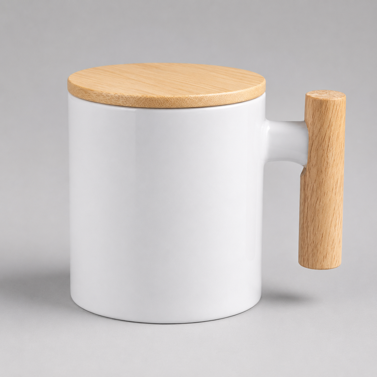 A white ceramic mug with a light natural wood lid and a matching vertical wooden handle, shown on a neutral gray background.