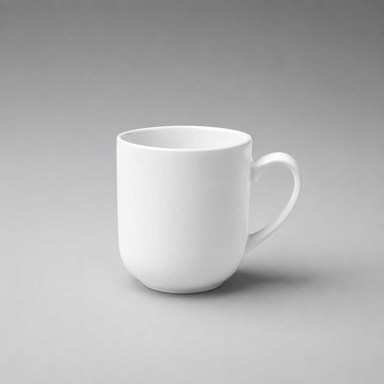 A plain white ceramic coffee mug with a curved handle, shown on a neutral gray gradient background.