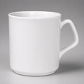 A plain white ceramic mug with a handle on the right side, photographed against a neutral gray background.