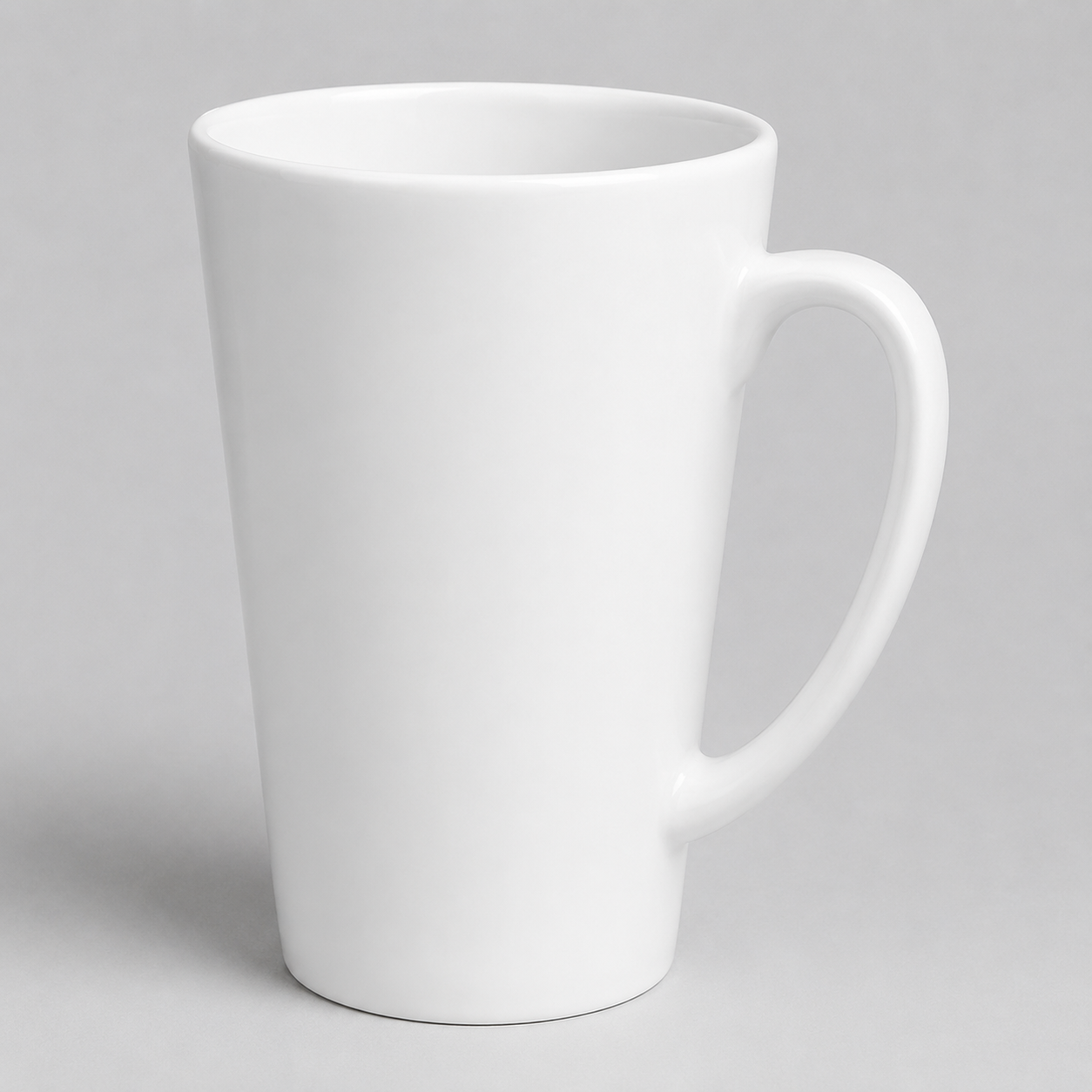 A classic white ceramic latte mug with a tapered body and a curved handle, shown on a neutral gray background.